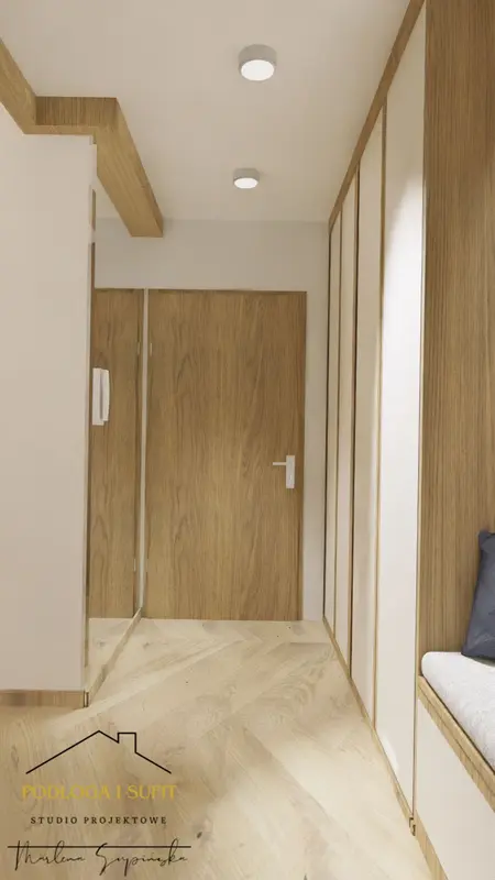 Przedpokój w stylu minimalistycznym z drewnianymi elementami i jasnymi kolorami.