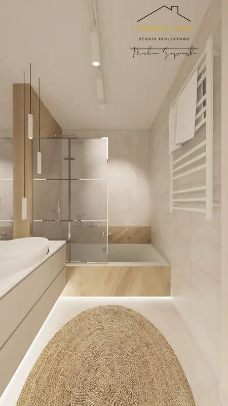 Wnętrze łazienki z minimalistycznym designem, drewnianymi elementami i wanną.