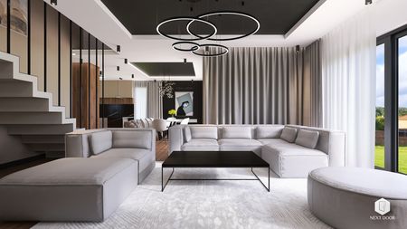 Wnętrze salonu z szarymi meblami i dużymi oknami, styl quiet luxury.