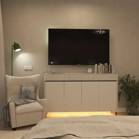 Wnętrze salonu z telewizorem, jasnymi meblami i rośliną, styl nowoczesny i skandynawski.