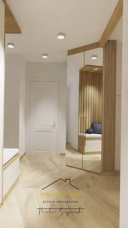 Minimalistyczny przedpokój z drewnianymi detalami i lustrem.