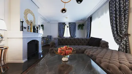 Wnętrze salonu w stylu glamour z szarym wypoczynkiem i złotymi detalami.