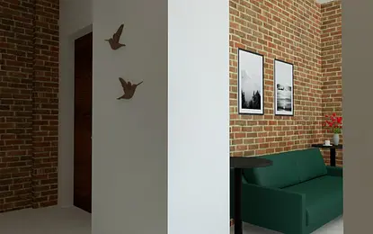 Nowoczesny salon z zieloną sofą i ceglaną ścianą, akcenty industrialne.