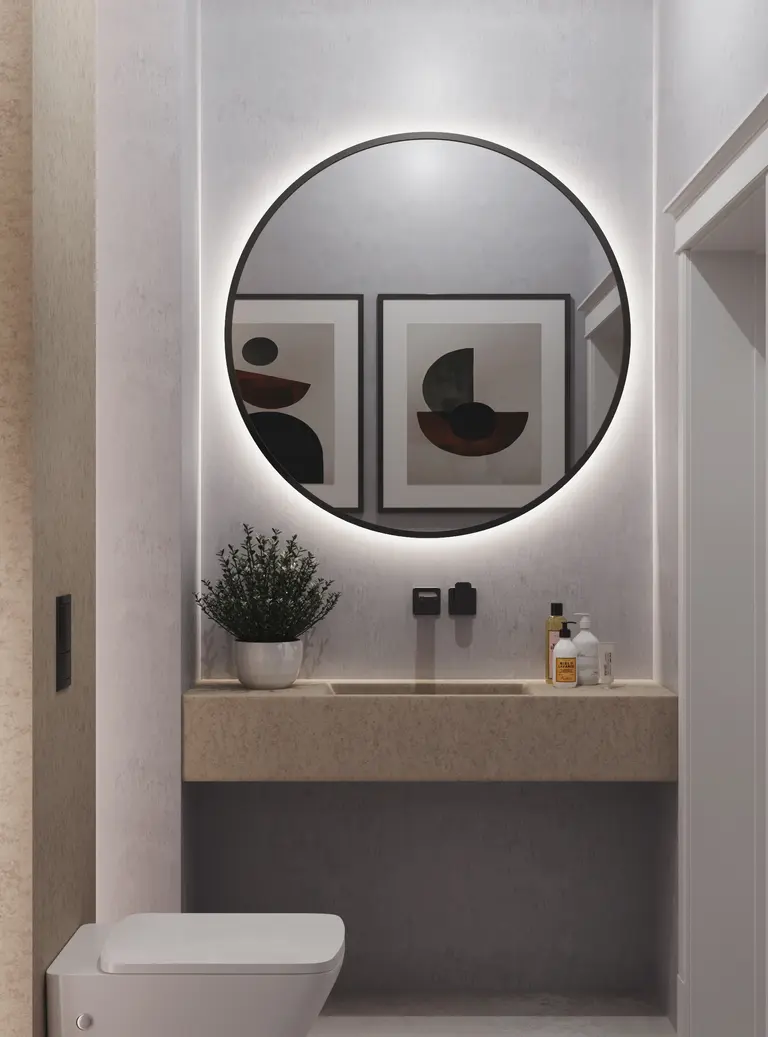 Minimalistyczna toaleta z okrągłym lustrem i nowoczesnym blatem. Wnętrze w stylu quiet luxury.