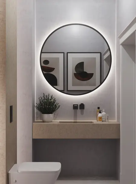 Minimalistyczna toaleta z okrągłym lustrem i nowoczesnym blatem. Wnętrze w stylu quiet luxury.