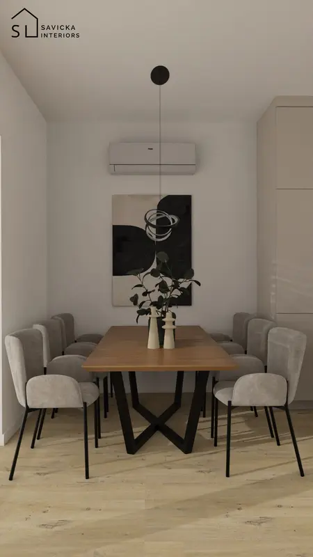 Elegancka jadalnia z drewnianym stołem, szarymi tapicerowanymi krzesłami i minimalistyczną lampą wiszącą nad stołem.